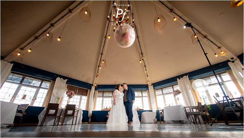 bride and groom in wedding breakfast room at stradey park hotel taken by Llanelli Wedding Photographer