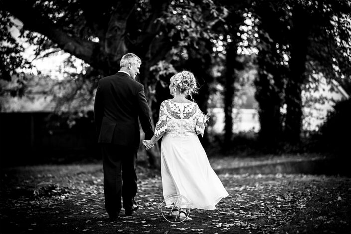 Black and White Portrait of Bride and Groom Walking Away