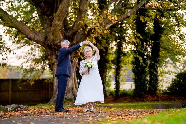 Bride and Groom Dancing with trees in background